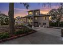 Two-story home's exterior, featuring a landscaped yard and driveway at 1580 Mac Chesney Dr, Tarpon Springs, FL 34689