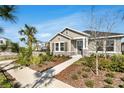 Charming single-story home featuring tidy landscaping, stone accents, and a serene neighborhood ambiance at 28732 Rambutan Dr, Wesley Chapel, FL 33543