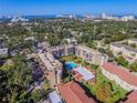 Aerial view of condo community showing pool, parking and ocean at 1243 S Martin Luther King Jr Ave # B205, Clearwater, FL 33756