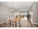 Bright dining area with table and chairs, overlooking living room at 13313 Gasparilla Rd # 402, Placida, FL 33946