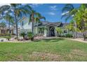 Beautiful two-story home with lush landscaping and a well-manicured lawn at 208 Driftwood Ln, Largo, FL 33770
