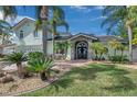 Charming two-story home boasts manicured landscaping, stone accents, and a welcoming entrance at 208 Driftwood Ln, Largo, FL 33770