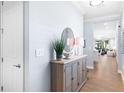 Bright entryway with wood console table, mirror, and view to the living area at 200 Soliera St, Nokomis, FL 34275