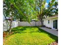 Lush, green backyard with a privacy fence creates a serene outdoor space at 3915 W San Pedro St, Tampa, FL 33629