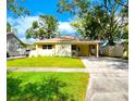 Charming single-story home with a well-manicured lawn, covered porch, and inviting curb appeal at 3915 W San Pedro St, Tampa, FL 33629