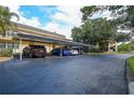 Community parking with covered spaces and well-maintained landscaping at 12300 Vonn Rd # 9105, Largo, FL 33774