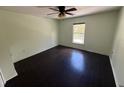 Bedroom with dark hardwood floors and ceiling fan at 3336 Bellericay Ln, Land O Lakes, FL 34638