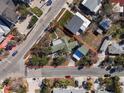 Aerial view of a single Gathering home located on a corner lot in a residential neighborhood at 7060 Boca Ciega Dr, St Pete Beach, FL 33706