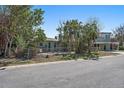 Single story home with a brick facade and a walkway to the front door at 7060 Boca Ciega Dr, St Pete Beach, FL 33706