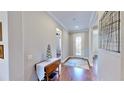 Bright and spacious entryway with hardwood floors and decorative accents at 11101 58Th Street E Cir, Parrish, FL 34219