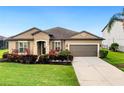 Single-story home with a two-car garage and manicured landscaping at 11101 58Th Street E Cir, Parrish, FL 34219