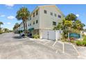 Exterior view of Bay View Villas building, showing parking and landscaping at 19807 Gulf Blvd # 128, Indian Shores, FL 33785