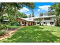 Large house with a well-maintained lawn and landscaping at 20333 Moss Branch Ct, Lutz, FL 33558