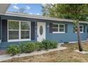 Newly renovated blue house, landscaping, and white trim at 3612 W Leila Ave, Tampa, FL 33611