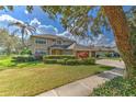 Two-story house with a three-car garage and lush landscaping at 5315 Cedarshake Ln, Valrico, FL 33596