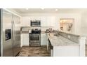 Modern kitchen featuring stainless steel appliances and granite countertops at 6317 S Lansdale Cir, Tampa, FL 33616