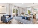 Living room featuring ample natural light, stylish furnishings, and a sliding glass door to outdoor patio at 4312 Red Banks Ln, Bradenton, FL 34208