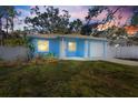 Charming light blue house with a landscaped yard at dusk at 615 W Virginia Ave, Tampa, FL 33603