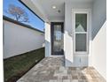 Front porch with paver stones and a modern door at 9442 Shorebird Ct, Parrish, FL 34219