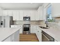 Modern kitchen with white cabinets, stainless steel appliances, and an island at 9442 Shorebird Ct, Parrish, FL 34219