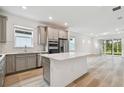 Modern kitchen with gray cabinets, white quartz countertops, and stainless steel appliances at 9446 Shorebird Ct, Parrish, FL 34219