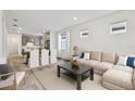 Open living room features a neutral color palette and flows into the kitchen at 9446 Shorebird Ct, Parrish, FL 34219