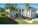 Stunning two-story home with mature landscaping and a welcoming front entrance with double doors at 15618 Shoal Creek Pl, Odessa, FL 33556