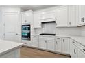 White kitchen cabinets, gas cooktop, and double wall oven at 11509 Waterway Dr, Parrish, FL 34219