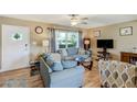 Inviting living room featuring a large window, comfortable seating, and stylish decor with wood-look flooring at 164 23Rd Sw Ave, Largo, FL 33778