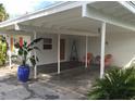 Home features carport with covered parking & seating area at 105 162Nd Ave, Redington Beach, FL 33708