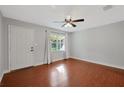 Bright living room with hardwood floors and ceiling fan at 3110 Camphor Dr, Plant City, FL 33566