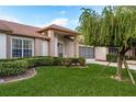 Brick home with lush landscaping and a screened garage at 5935 Precious View Ct, New Port Richey, FL 34655