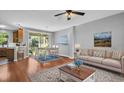 Bright open-concept living and dining area with hardwood floors and sliding glass doors to the outdoors at 12432 Country White Cir, Tampa, FL 33635