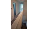 Upstairs hallway with carpet and access to bedrooms and bathrooms at 7002 Ripple Pond Loop, Zephyrhills, FL 33541