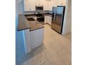 Modern kitchen with stainless steel appliances and granite countertops at 7002 Ripple Pond Loop, Zephyrhills, FL 33541