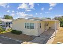 Exterior view of a single-wide mobile home with carport at 619 Pelican S Dr, Oldsmar, FL 34677