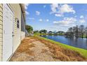 Side yard of home showing lake view at 619 Pelican S Dr, Oldsmar, FL 34677