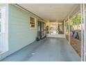 Covered carport with concrete flooring and screened enclosure at 9696 Groveland St, Seminole, FL 33772