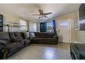 Living room with tile flooring and sectional sofa at 9696 Groveland St, Seminole, FL 33772