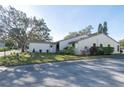 Single-story home with light-colored walls and landscaping at 3207 Green Dolphin St, Tarpon Springs, FL 34689