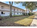 Two-story condo building with balconies, windows, and mature trees at 141 Lakeview Way, Oldsmar, FL 34677
