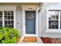 Inviting front door entrance with a welcoming mat and wreath at 2345 Lake Woodberry Cir, Brandon, FL 33510