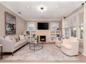 Bright living room with fireplace, built-ins, and hardwood floors at 3512 W Granada St, Tampa, FL 33629