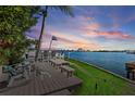 Spacious waterfront deck with seating, enjoying sunset views at 485 41St Ave, St Pete Beach, FL 33706