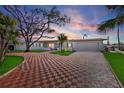 Charming ranch home with a checkered brick driveway and mature landscaping at 485 41St Ave, St Pete Beach, FL 33706