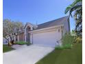 Two-car garage with a paved driveway and landscaping at 4799 Klosterman Oaks Blvd, Palm Harbor, FL 34683