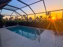 Relaxing screened-in pool area with serene views and a beautiful sunset at 9921 Pier Point Ter, Parrish, FL 34219