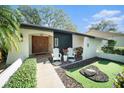 Modern home's entrance with double doors and putting green at 2383 Indian E Trl, Palm Harbor, FL 34683