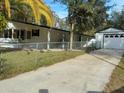 Front view of manufactured home with detached garage at 10040 Jungle St, New Port Richey, FL 34654