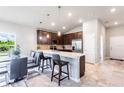 Modern kitchen featuring stainless steel appliances and a breakfast bar at 174 Green Oak Park, Rotonda West, FL 33947